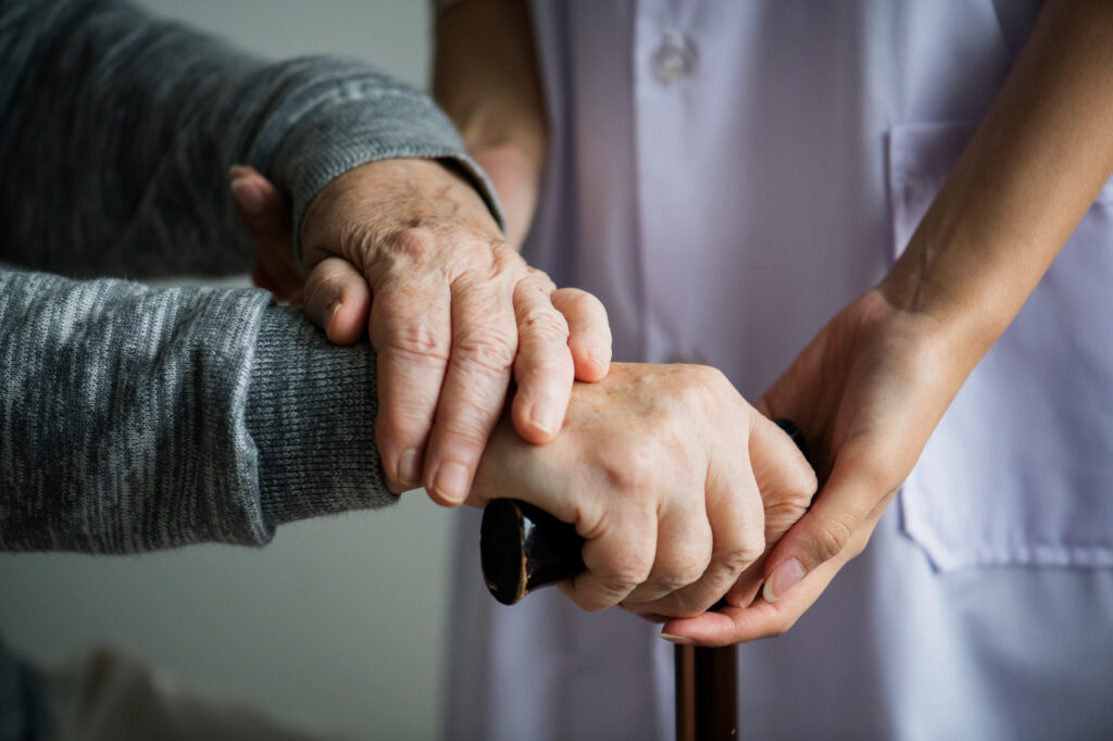 hands of an elderly and a caregiver
